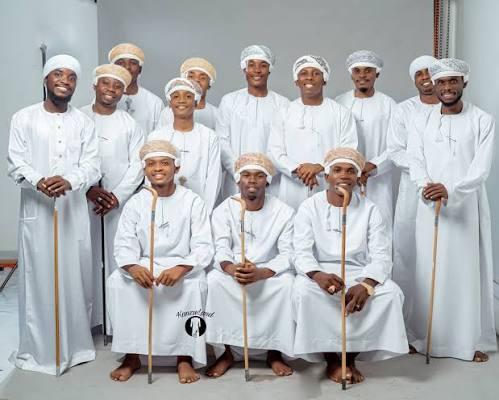 Group portrait of a groom's party in white kanzu