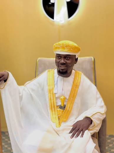 Customer in an ivory and gold formal kanzu set
