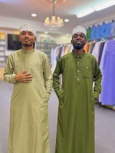 Two men in olive kanzu inside the Kanzuland shop