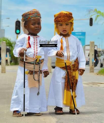 Two boys in matching kids' kanzu and vilemba sets